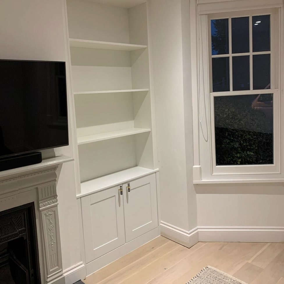 Bespoke White Alcove Unit next to Fireplace in Windsor Home